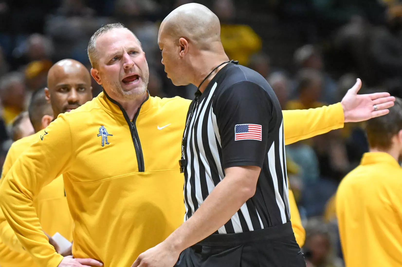 Head coach Darian DeVries argues a call