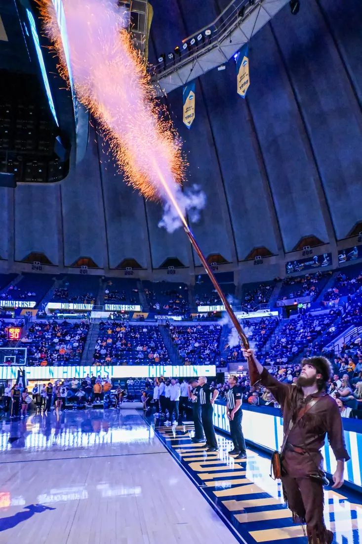 The Mountaineer mascot Braden Adkins fires the musket.