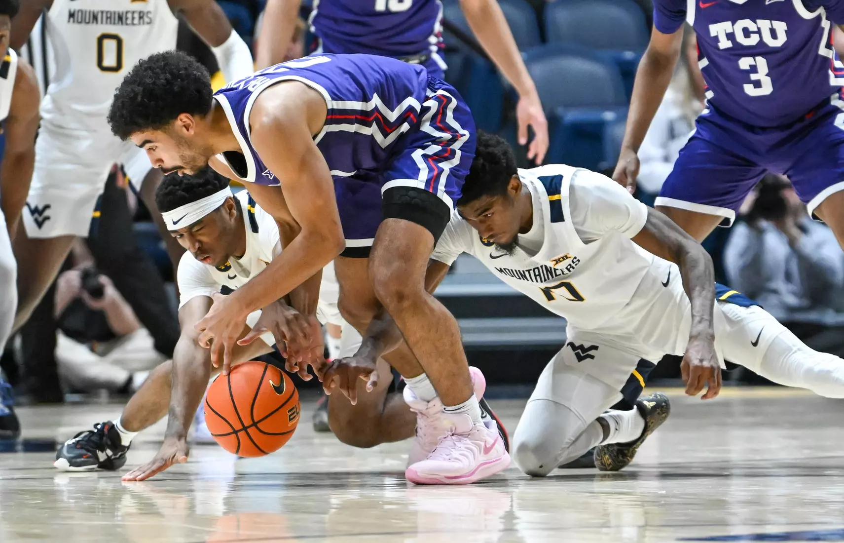 KJ Tenner and Sencire Harris go for the loose ball.