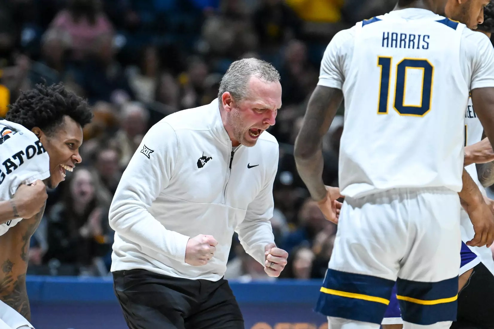 Head coach Darian DeVries celebrates a big play by Eduardo Andre.