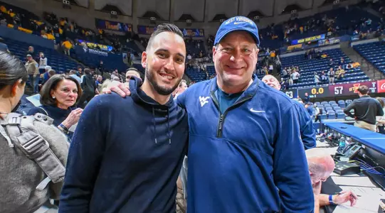 Jonnie West and head football coach Rich Rodriguez.