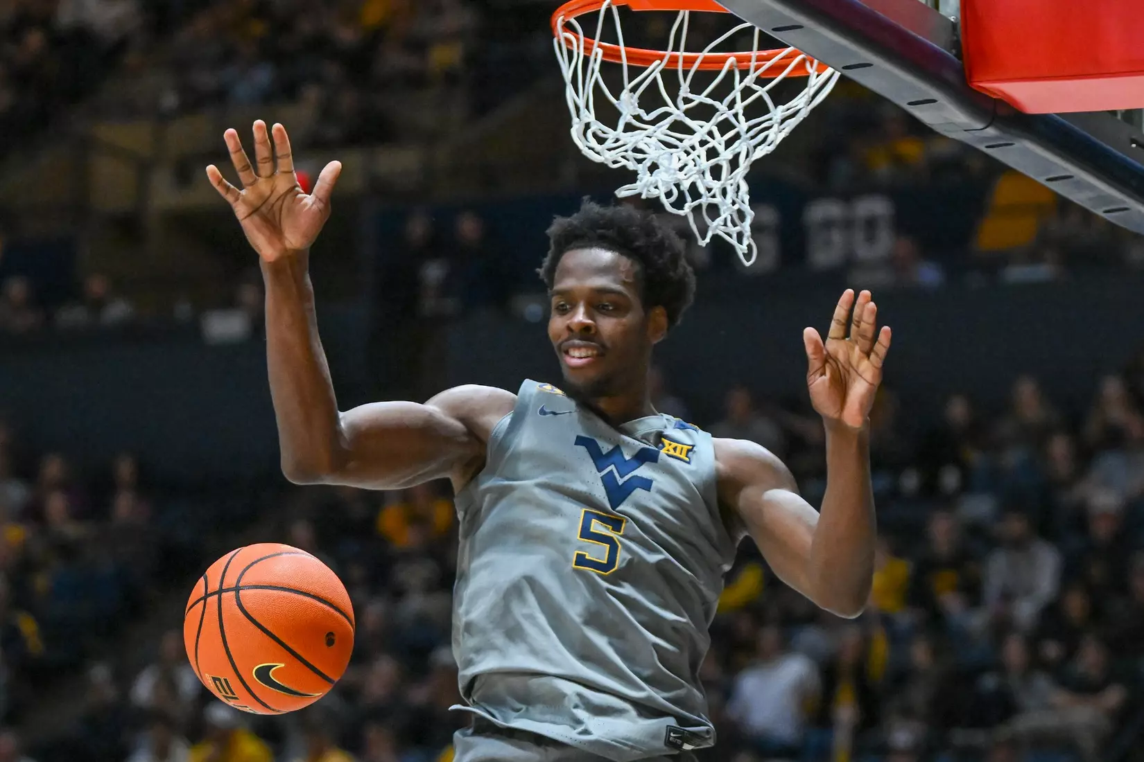 Toby Okani is all smiles after a big dunk.