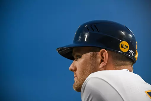 Steve Sabins watches from the dugout.
