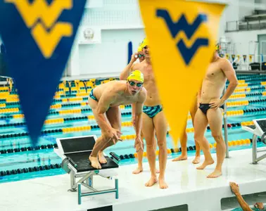 Parker Sterlitz prepares to dive into the water from the starting block.