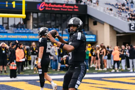 West Virginia players warm up prior to their game against Arizona at Milan Puskar Stadium in Morgantown, W.Va., on Oct. 10, 2026.