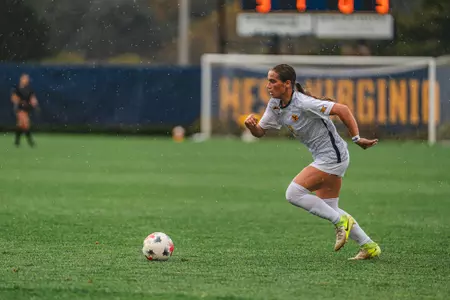 Olivia Shertzer dribbles the ball during a game at Dick Dlesk Soccer Stadium.