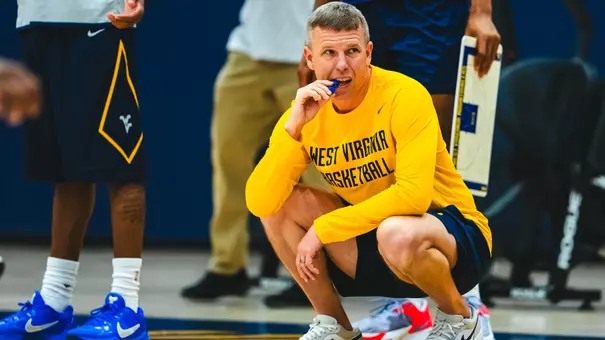 West Virginia coach Ross Hodge observes a preseason practice inside the Basketball Practice Facility earlier this fall.