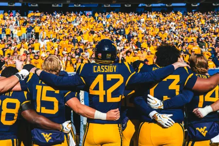 West Virginia fans and players sing "Take Me Home, Country Roads" after West Virginia's win against Cincinnati on Oct. 17, 2026.