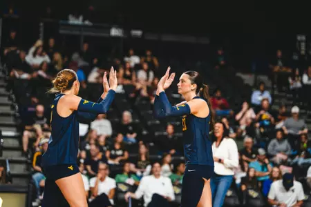 Macie Smith and Alexis Finnvold high five when playing against UCF on Oct. 18