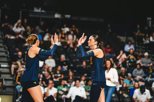 Macie Smith and Alexis Finnvold high five when playing against UCF on Oct. 18