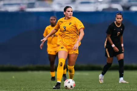 Jacey Rase dribbles a ball during a match at Dick Dlesk Soccer Stadium.