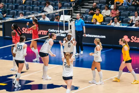 WVU Volleyball celebrates as they defeat Arizona on Oct. 23