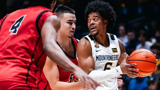 Guard Martin Somerville looks for an open teammate during West Virginia's exhibition men's basketball game against Wheeling University at the WVU Coliseum, on Wednesday, Oct. 28, 2026.