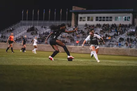 Tyler Clyburn dribbles a ball during a match at Dick Dlesk Soccer Stadium.