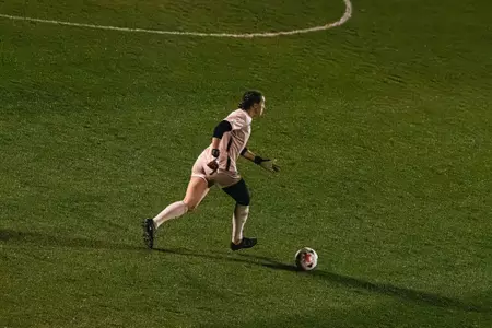 Bailey Herfurth dribbles a ball during a match at Dick Dlesk Soccer Stadium.