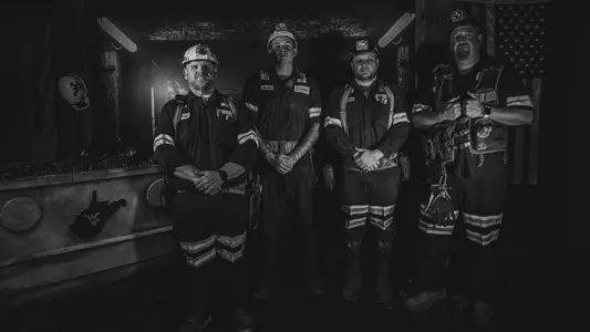 Area coal miners pose for a picture inside a mine shaft ahead of Saturday's "Coal Rush" game against Arizona to celebrate the state's coal mining heritage.