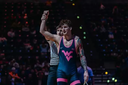 Ty Watters raises his arm after winning a bout against Missouri on Feb. 6, 2026.