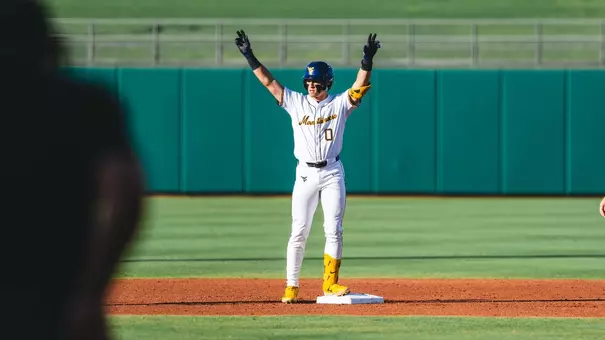 Matthew Graveline celebrates after getting a hit against Kansas State in the Big 12 quarterfinals