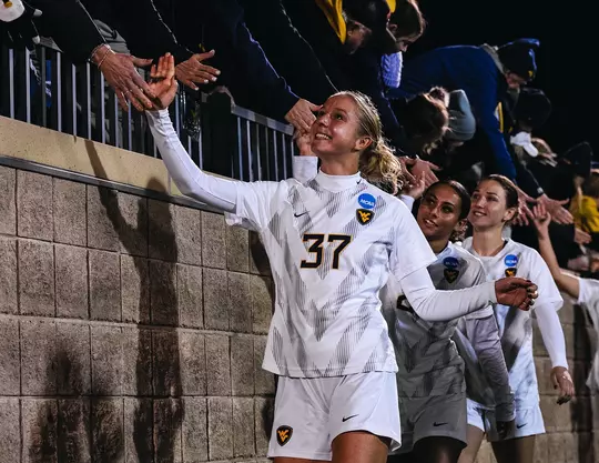 West Virginia women's soccer players celebrate their 5-0 NCAA Tournament victory over Wagner at Dick Dlesk Stadium in Morgantown, West Virginia, on Friday, Nov. 14, 2025.