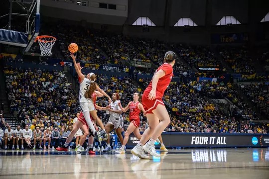 West Virginia's Gia Cooke drives for a basket during the Mountaineers' NCAA Tournament first-round game against Miami, Ohio played at Hope Coliseum on Saturday, March 21, 2026.