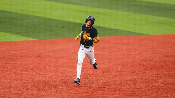 Gavin Kelly rounds the bases after hitting a home run