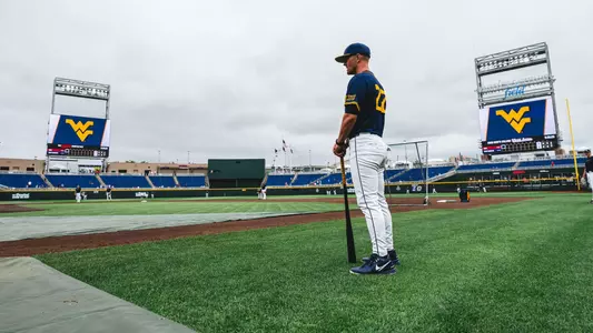 West Virginia coach Steve Sabins observes his team practicing at Charles Schwab Field in Omaha, Nebraska, on the eve of West Virginia's first-ever College World Series game against Troy on Friday, June 12, 2026.