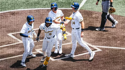 Tyrus Hall celebrates after hitting a grand slam against Cal Poly in game one of the NCAA Super Regionals