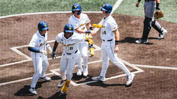 Tyrus Hall celebrates after hitting a grand slam against Cal Poly in game one of the NCAA Super Regionals