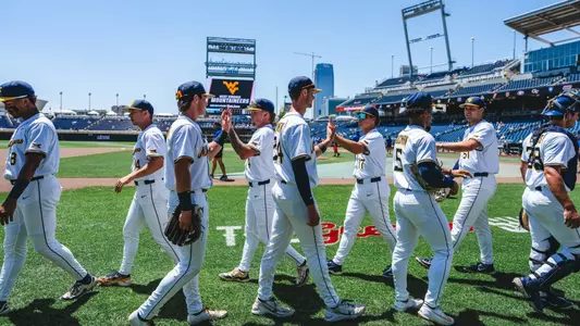 WVU baseball players high five before game against North Carolina