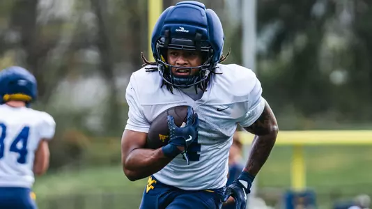 West Virginia running back Cam Cook performs a drill during spring football practice at the Steve Antoline Family Practice Field in Morgantown, W.Va.