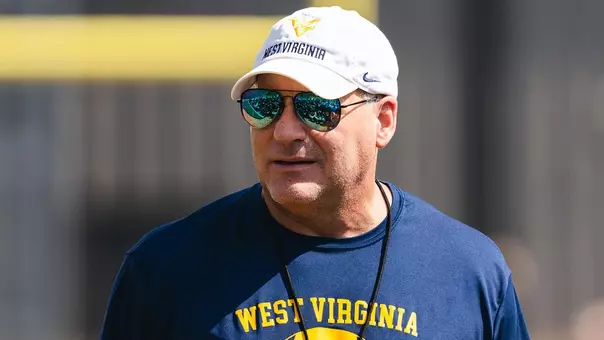 West Virginia coach Rich Rodriguez talks to his team after an August morning workout on the Steve Antoline Family Practice Facility in Morgantown, West Virginia.