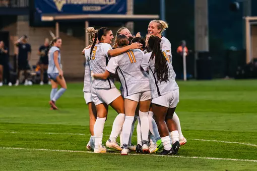 Members of the WVU women's soccer team celebrate after a goal on Aug. 13, 2026.