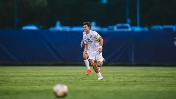 Isaac Scheer runs around during a soccer game against Pitt