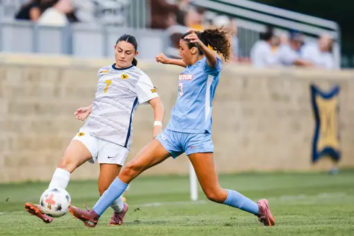 Alexis Pashales of the WVU women's soccer team battles for a ball against a Dayton defender during a match on Aug. 13 in Morgantown.