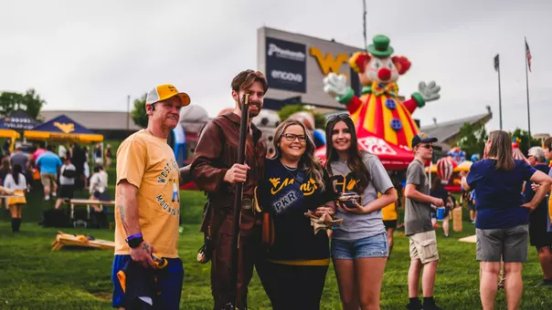 The WVU Mountaineer poses with fans at an event at Milan Puskar Stadium.