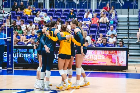 WVU Volleyball team huddles after a point