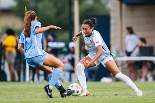 Hannah Heimuli of the WVU women's soccer team battles for a ball during a game against Dayton.