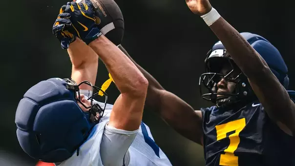An unidentified West Virginia player makes a catch during fall football practice on the Steve Antoline Family Practice Field on Wednesday, August. 5, 2026. Senior defensive back Chams Diagne (7) is defending.