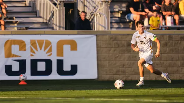 Isaac Scheer dribbles the ball against St. Bonaventure