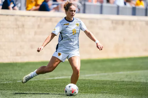 Alina Gnädig prepares to pass a ball during a game at Dick Dlesk Soccer Stadium.