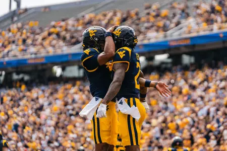 Two players celebrate after scoring a touchdown against UT Martin at Milan Puskar Stadium on Sept. 12, 2026.