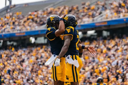 Two players celebrate after scoring a touchdown against UT Martin at Milan Puskar Stadium on Sept. 12, 2026.