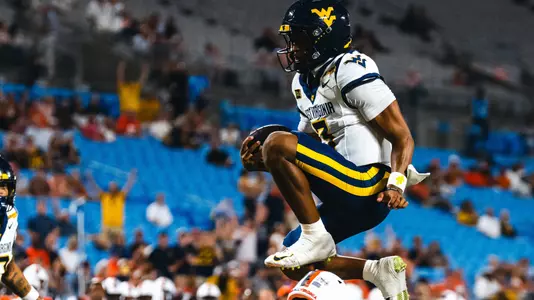 Quarterback Michael Hawkins Jr. scores a 13-yard touchdown in the first quarter of West Virginia's 38-27 victory over 25th-ranked Virginia on Saturday, Sept. 19, 2026 at Bank of America Stadium in Charlotte, North Carolina.