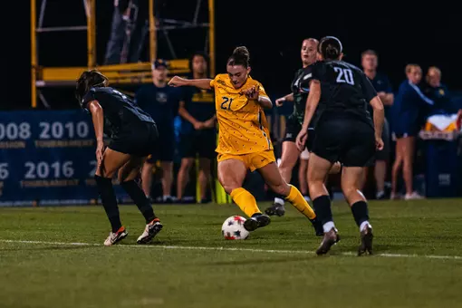 Alexis Re dribbles past a defender during a match at Dick Dlesk Soccer Stadium.