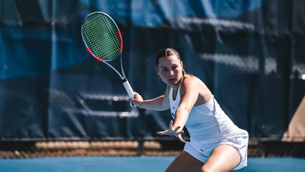 Lucia Tognoni returns a serve during a tennis match
