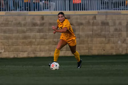 Jacey Rase dribbles down the field during a match at Dick Dlesk Soccer Stadium.
