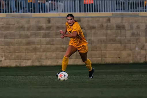 Jacey Rase dribbles down the field during a match at Dick Dlesk Soccer Stadium.
