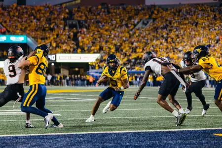 Michael Hawkins Jr. (3) rushes for a touchdown in the first quarter against Oklahoma State on Sept. 26, 2026, in Morgantown, W.Va.