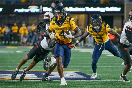 Cam Cook rushes against Oklahoma State at Milan Puskar Stadium in Morgantown, W.Va., on Sept. 26, 2026.