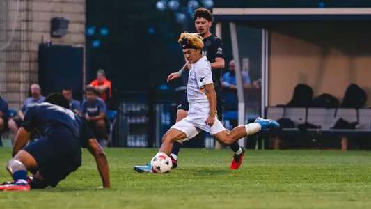 Kanta Ishii kicks the ball against Akron
